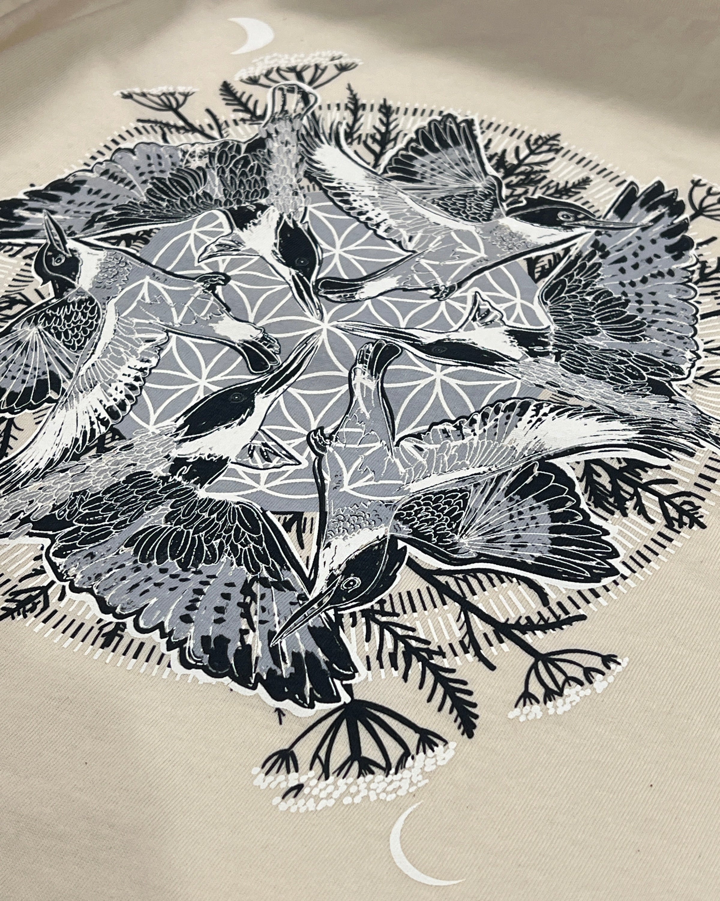 A blue and white mandala design with 6 kingfisher, yarrow, and moons