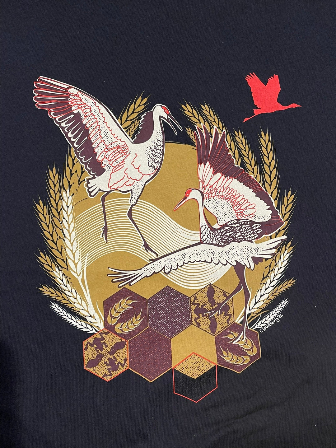 Decorative design on a black background featuring birds, geometric shapes, and wheat.