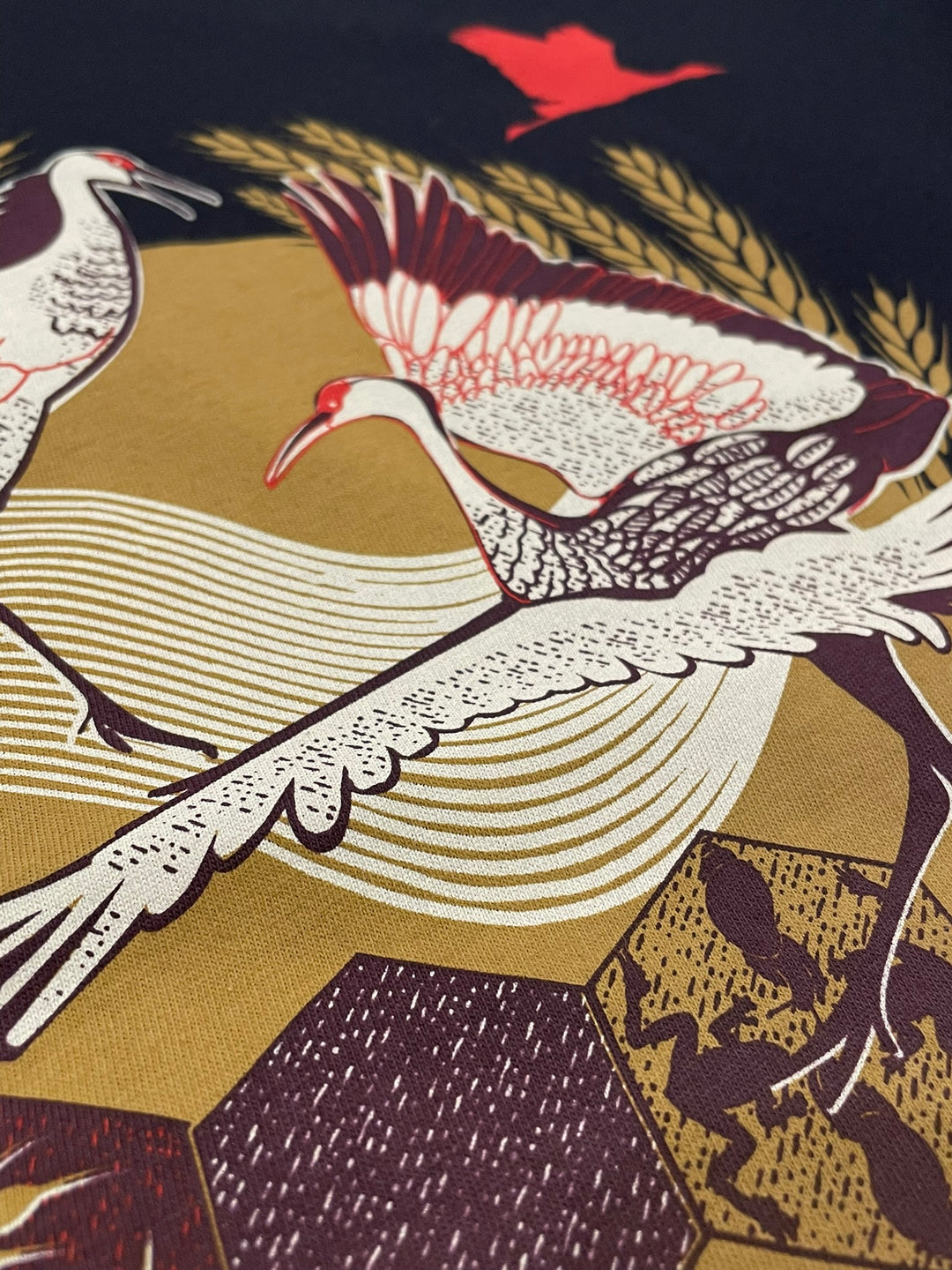 Pattern of cranes and geometric shapes on a fabric background