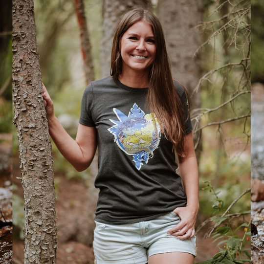 Woman wearing a t-shirt with a colorful design in a forest setting